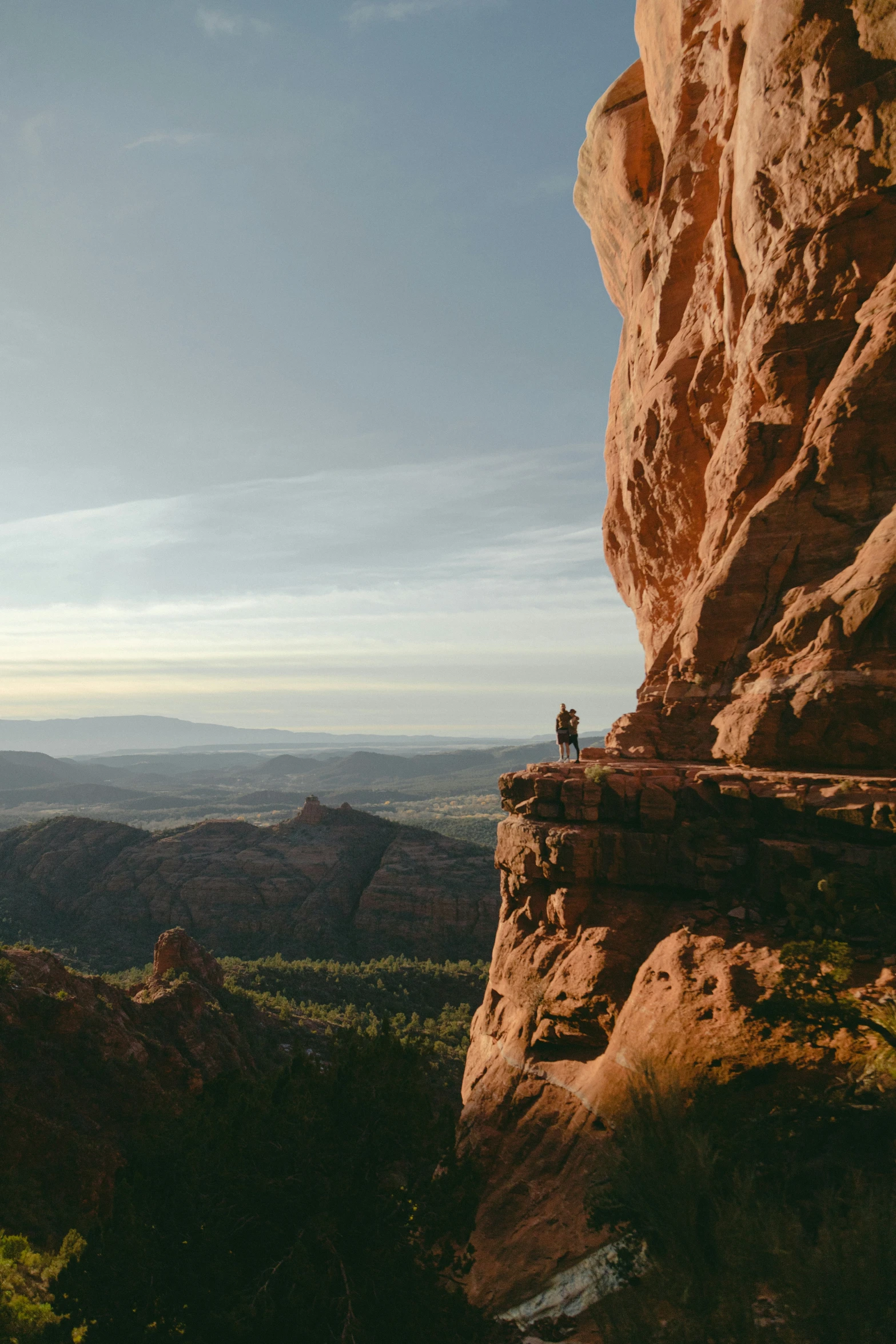 a man standing on top of a large cliff