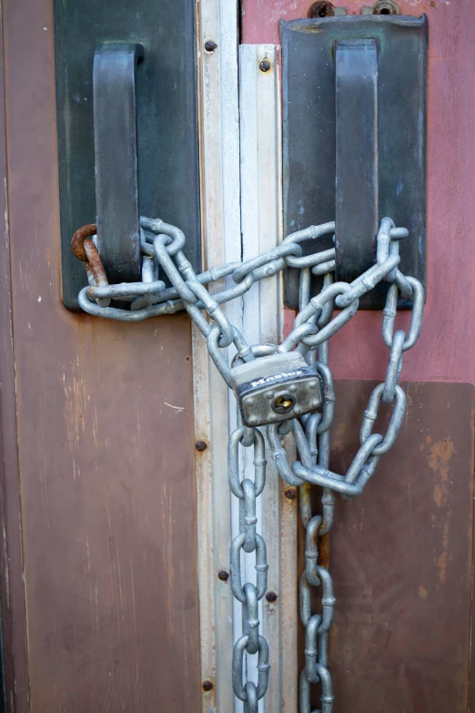 a metal chain attached to the front door of a building