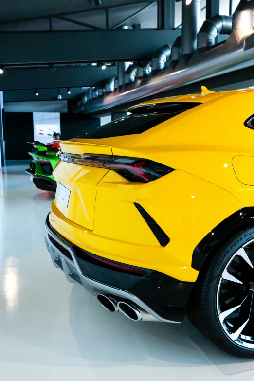 two different colored sports cars are shown in the showroom