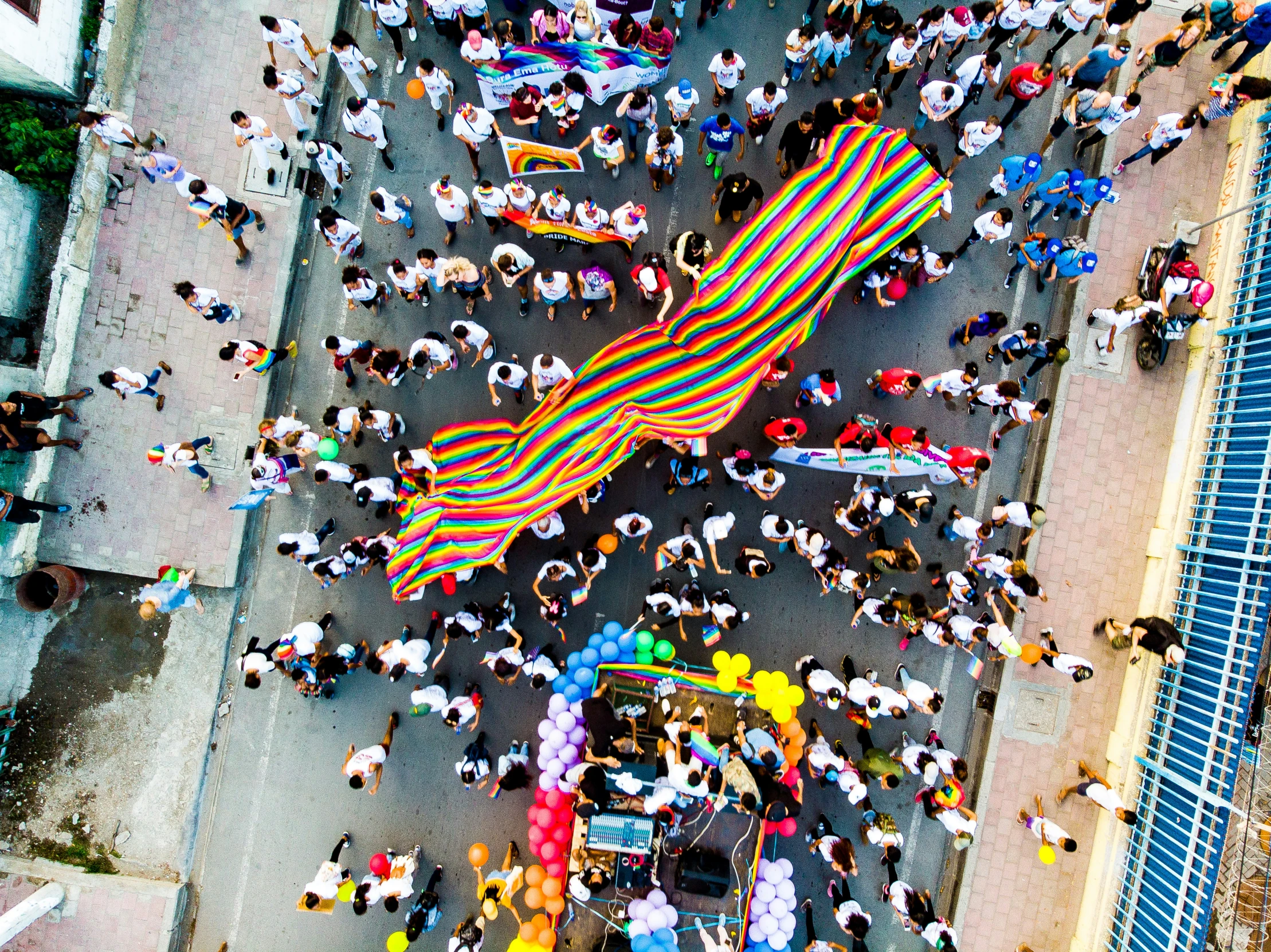 an overhead view of a parade with a bunch of people on the street