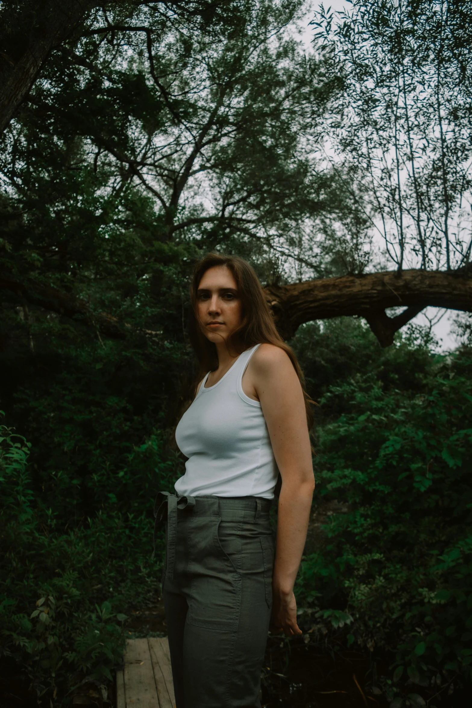 a women who is standing near some trees