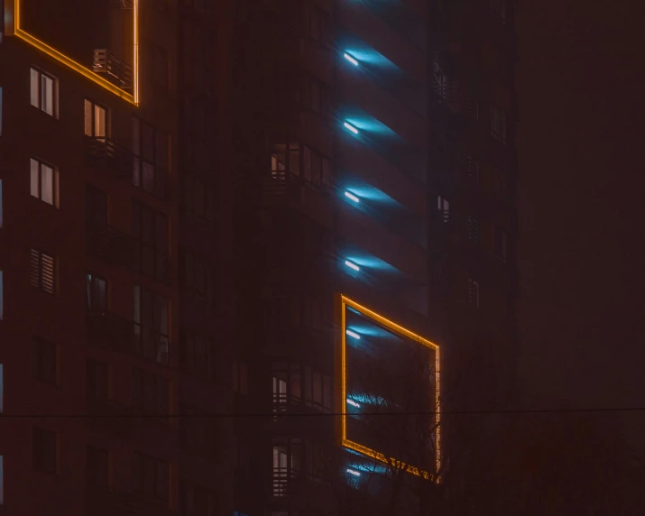 tall building with illuminated lights on it at night