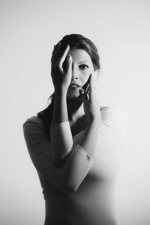 a woman standing while talking on her phone