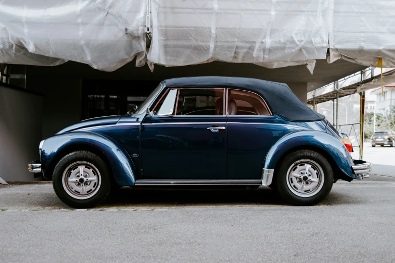 a blue vw bug is shown from the back