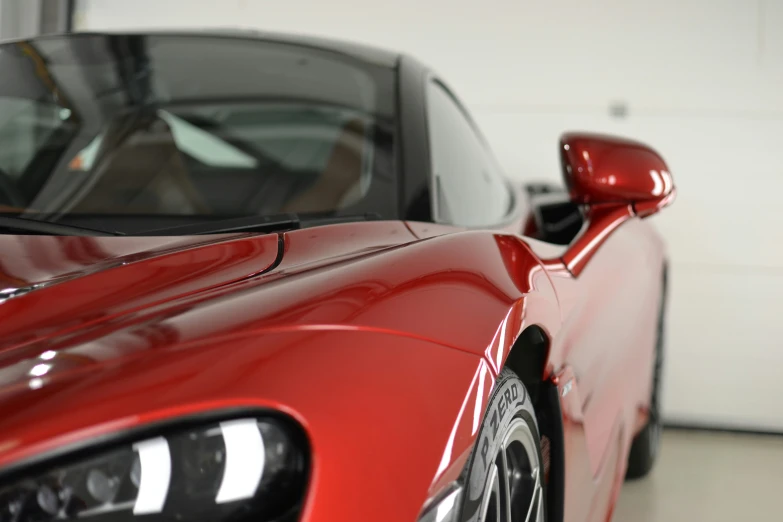 a red sports car parked next to a garage door