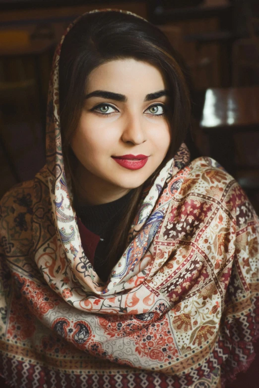 a young woman with a scarf wrapped around her head and her eyes are half closed