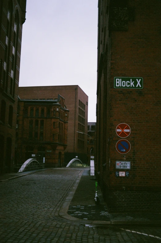 the street is brick and has two street signs