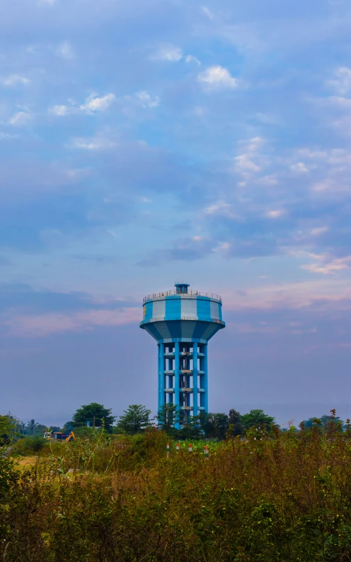 a blue water tower with a light on top