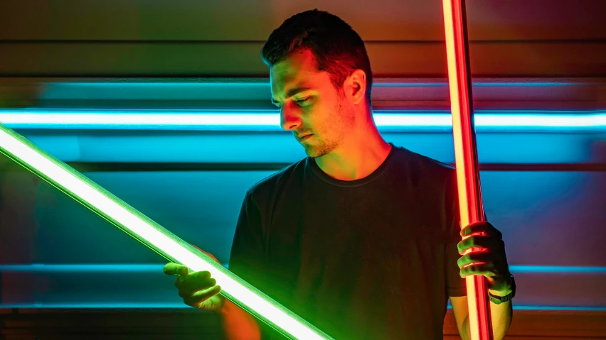 a man holds a light saber with the same color as his arm