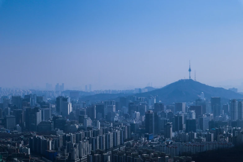 a city skyline with some hills in the distance