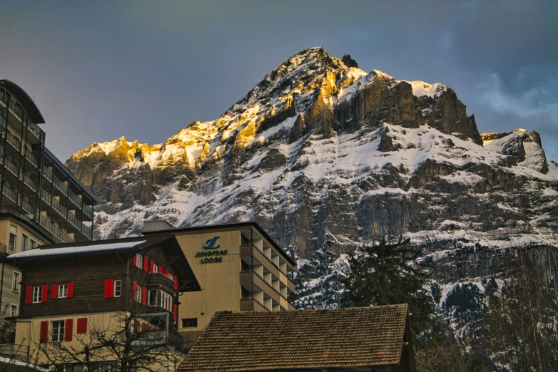 the snow covered mountain is near a town