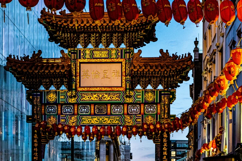 a colorful and intricate clock sitting over the road