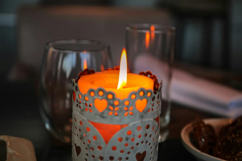 a lit candle sitting on top of a table