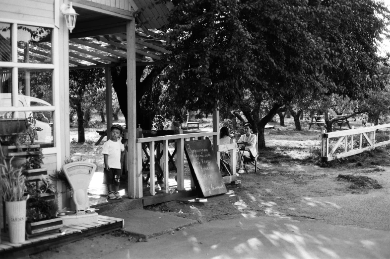 a black and white picture of women cleaning the yard