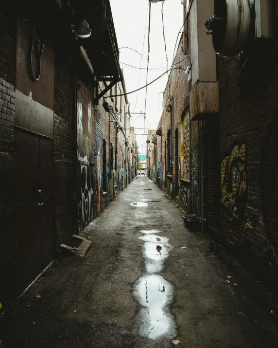 an alley that has graffiti all over it