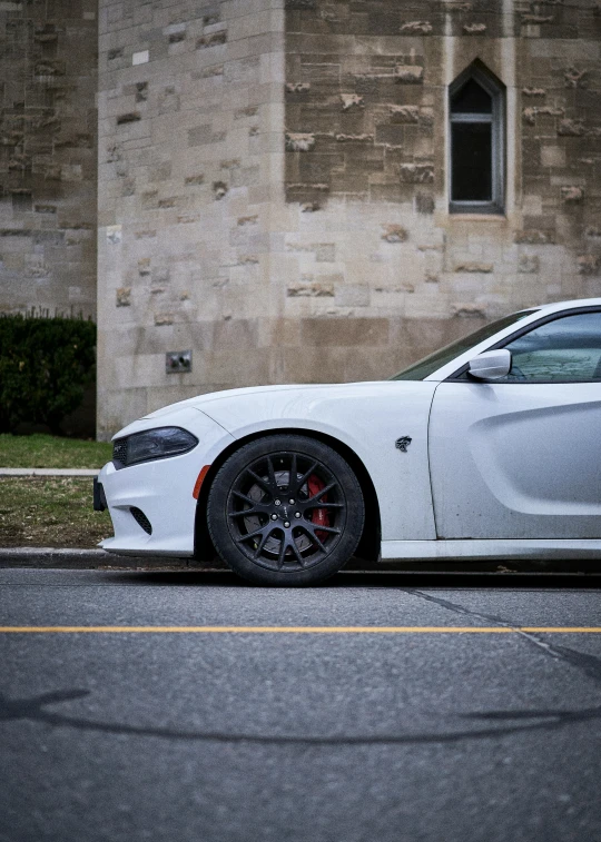 the front of a car parked in front of a stone building