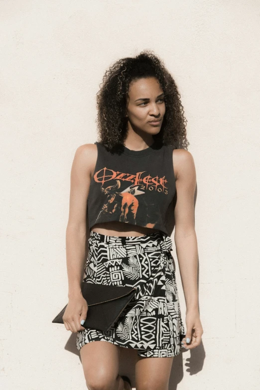 the model poses for a picture in a cropped t - shirt and skirt