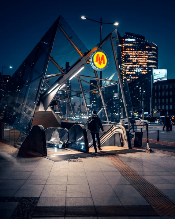 a person standing on the steps next to a mirror cube