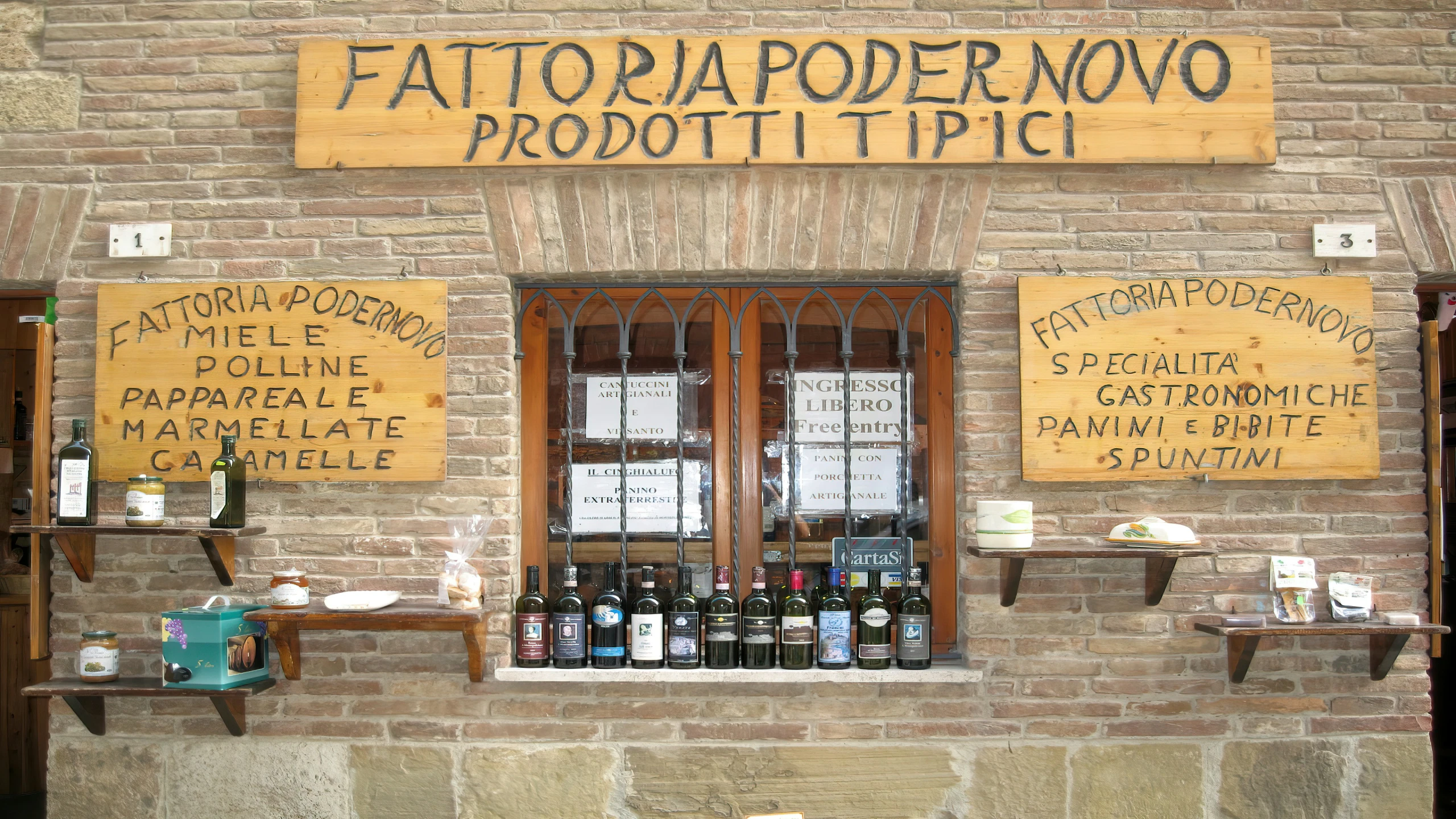 a store front with wooden signs outside