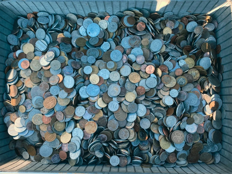 a basket filled with lots of different colored coins