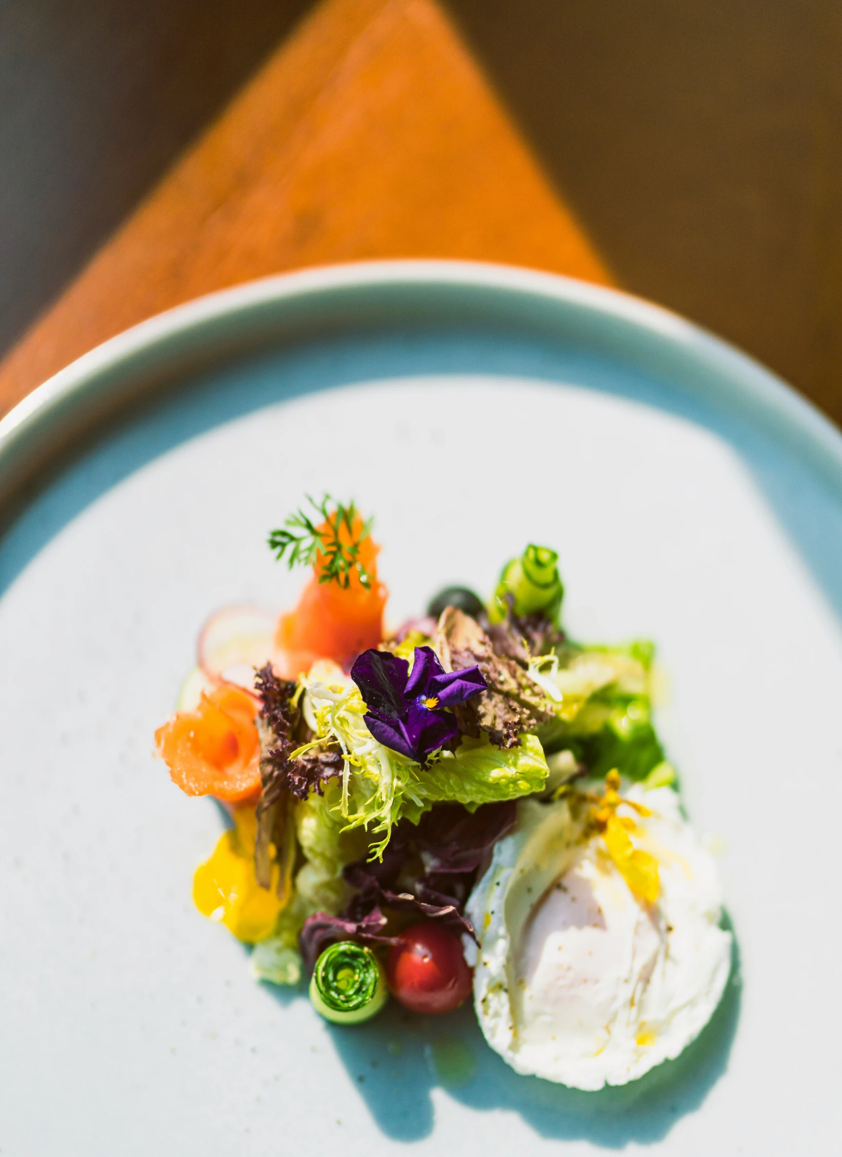 plate of food with vegetables and an egg on top