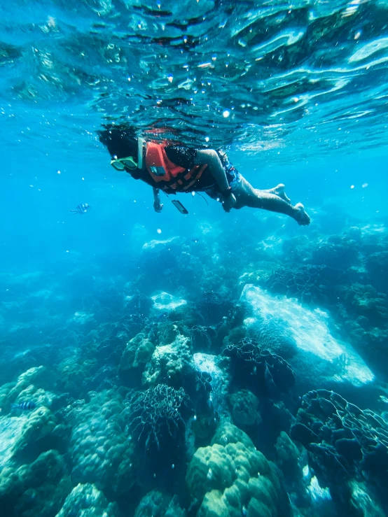 a man swimming in the ocean with his feet on the ground