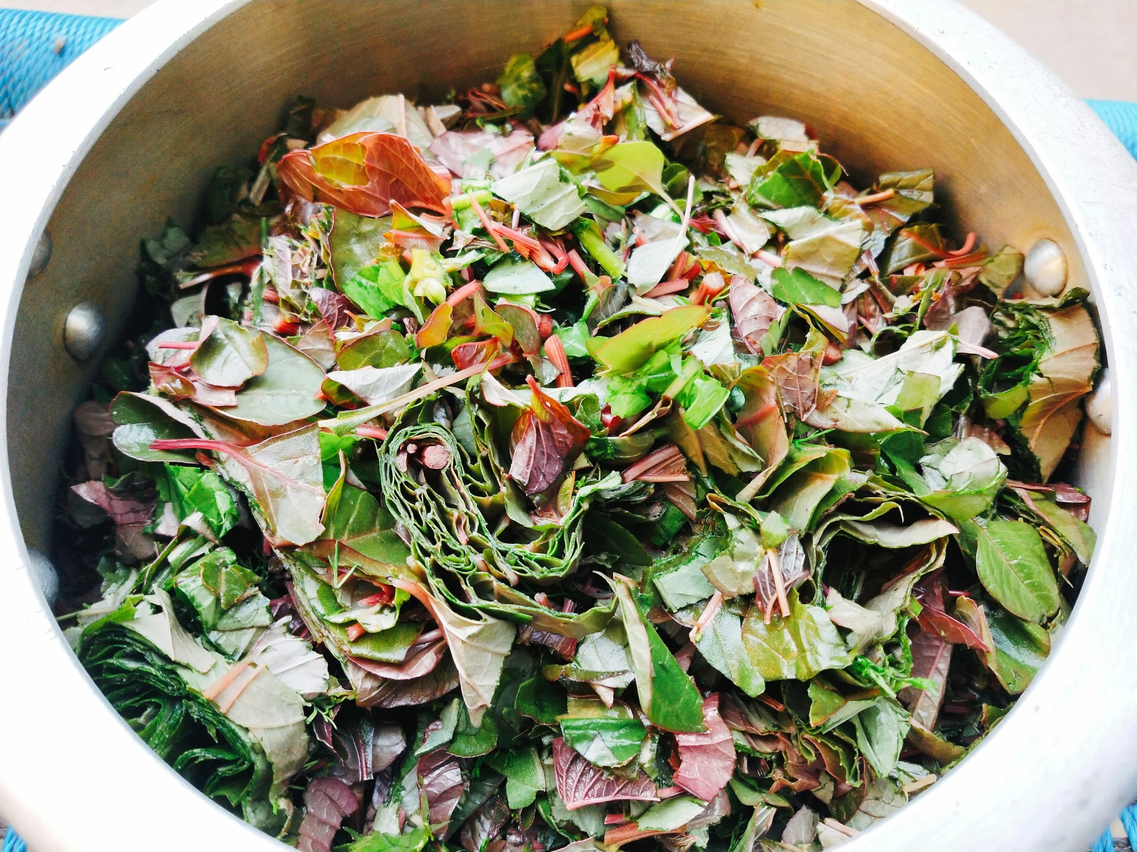 an up close picture of a pile of vegetables in a white bowl