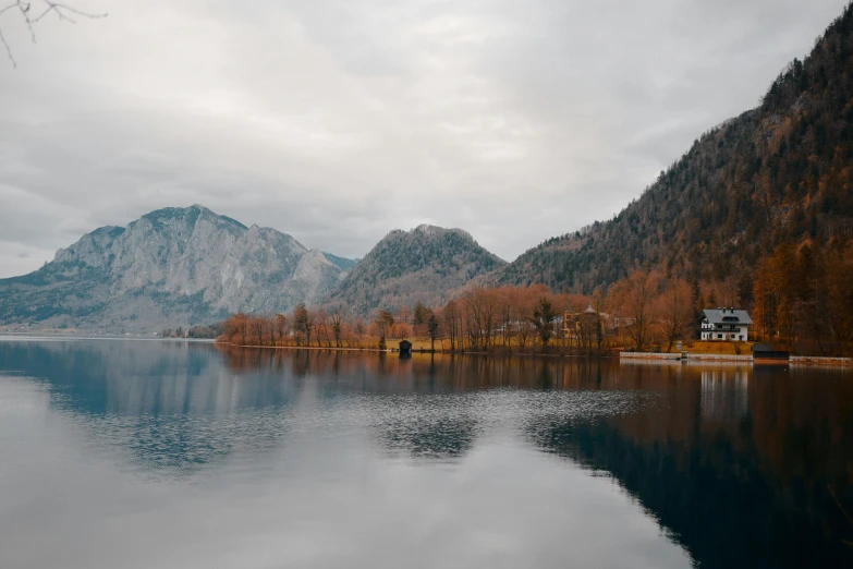 a scenic landscape with mountains reflected in a still lake