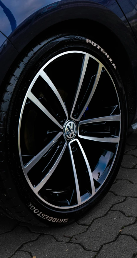 a volkswagen wheel on the road with another vehicle