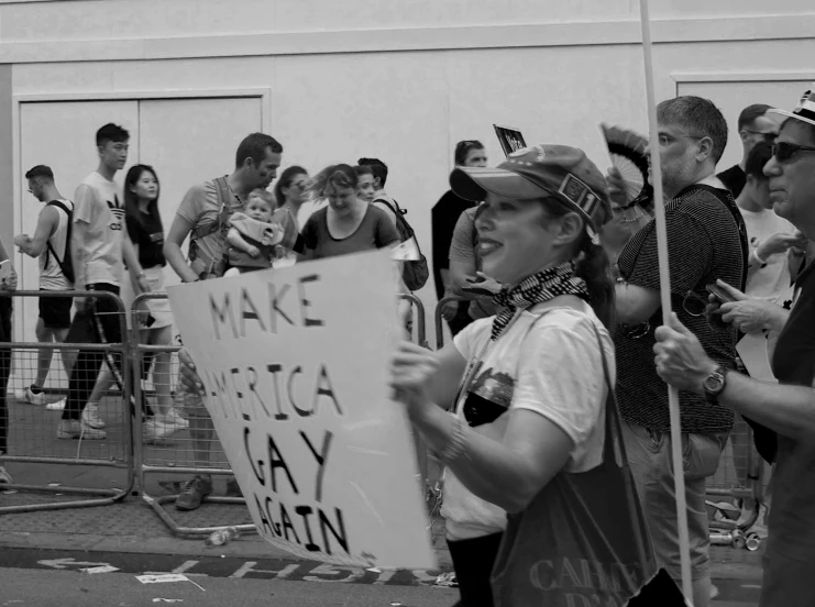 a woman holds a sign in protest outside