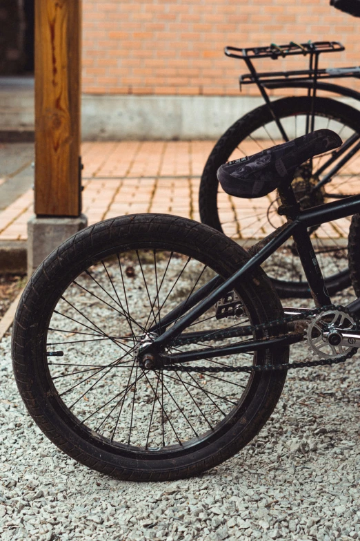 a close up of a bike on a street with the tire out