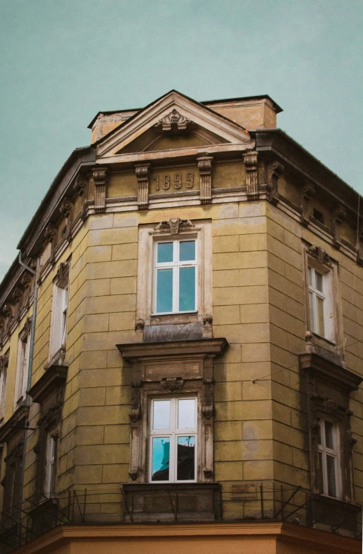 an image of a large yellow building from below