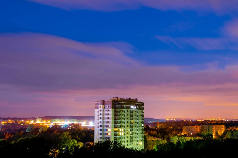 the night sky is illuminated by skyscrs as lights shine