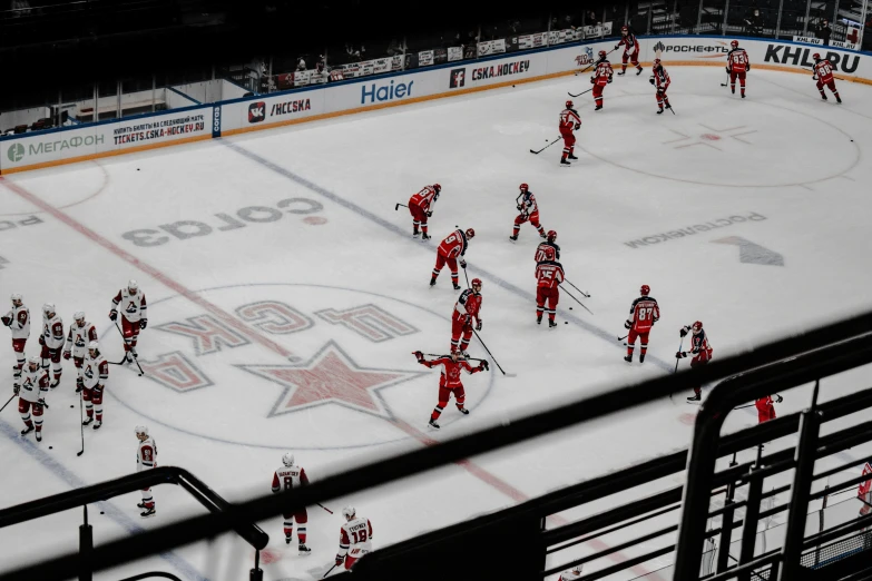 hockey players on an ice rink in the shadows