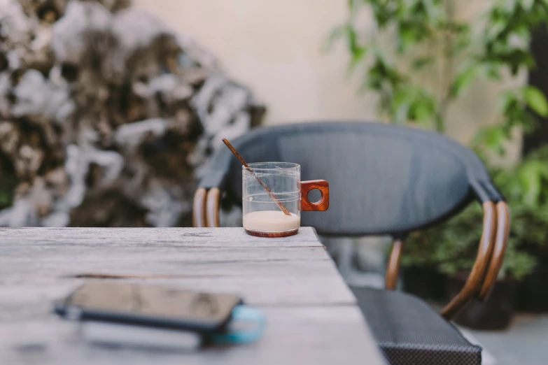 a glass filled with milk sits on a table