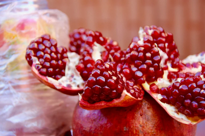 a pomegranate sitting on top of an orange and pink table