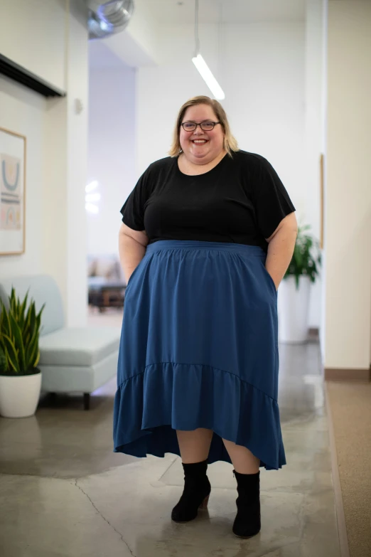 a woman with big  wearing a blue skirt