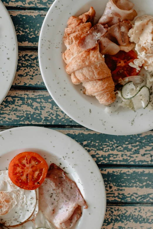 two white plates with different types of food