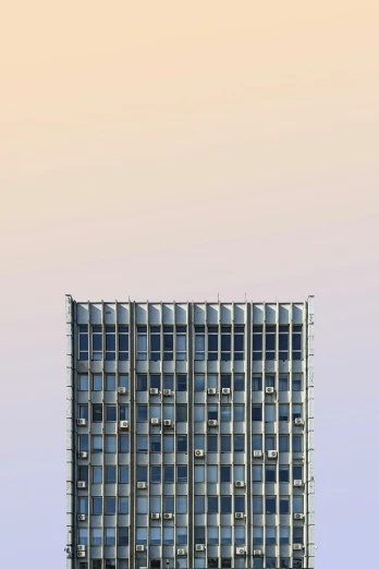 a building in front of a white and light pink sky