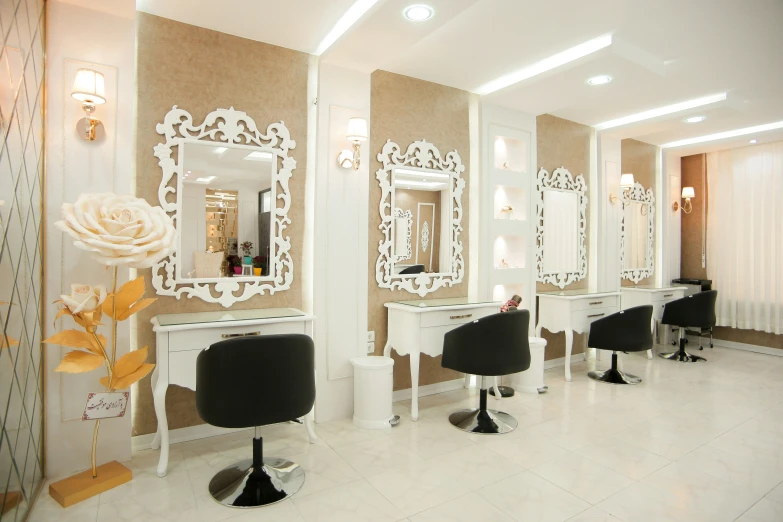 a salon has hair chairs and mirrors with hairdryers on the table