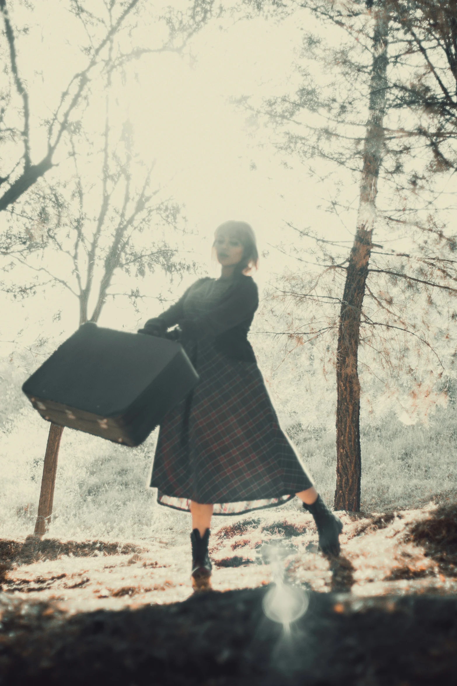 a woman dressed in black and red poses for a picture with her bag