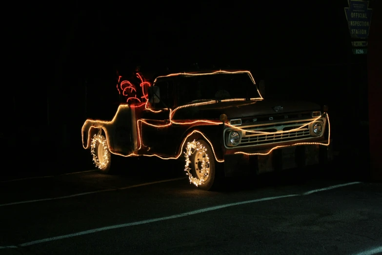 a truck lit up with christmas lights in the dark