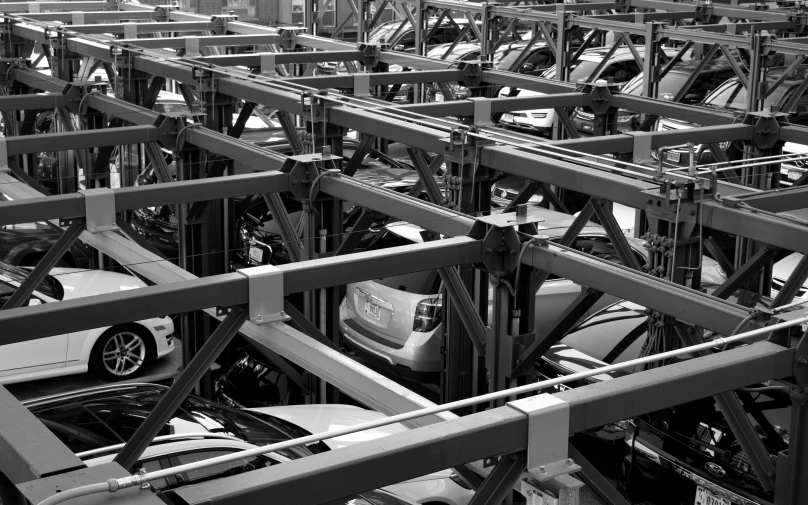 cars are parked in large rows of steel racks
