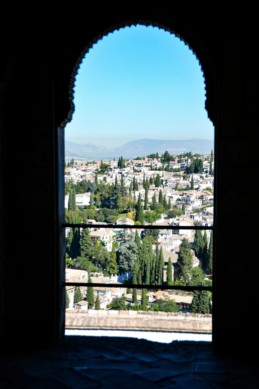 an arch leading to the view from a large window