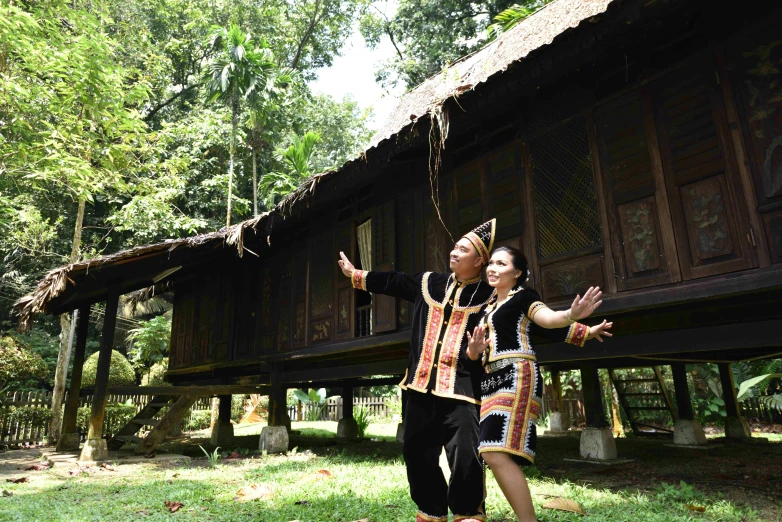 two people in a field reaching into the air