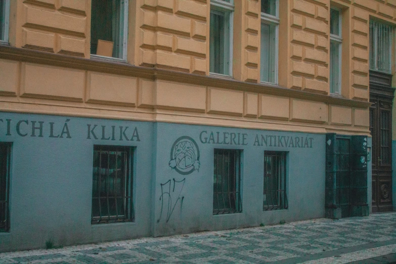 a city street corner with a building that has graffiti writing on it