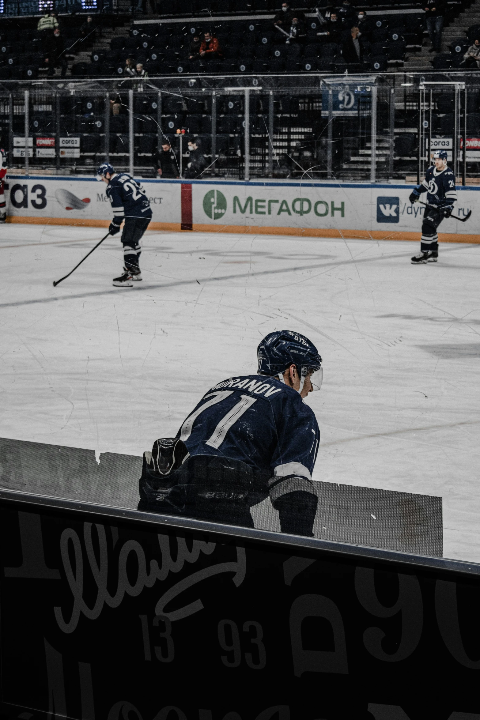 hockey players are on the ice while fans watch