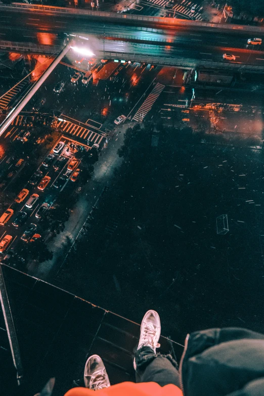 a person's feet in a glass top skywalk