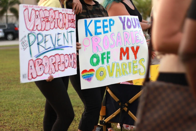 people holding signs saying no vids are prevent against propensities