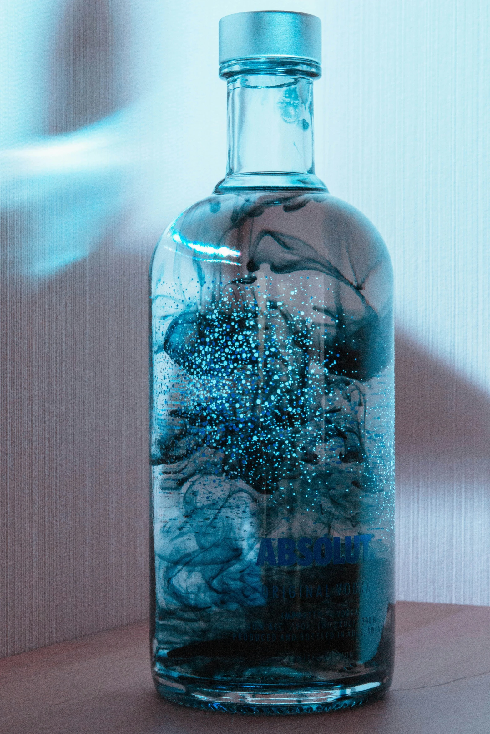 a clear bottle of liquid on a table